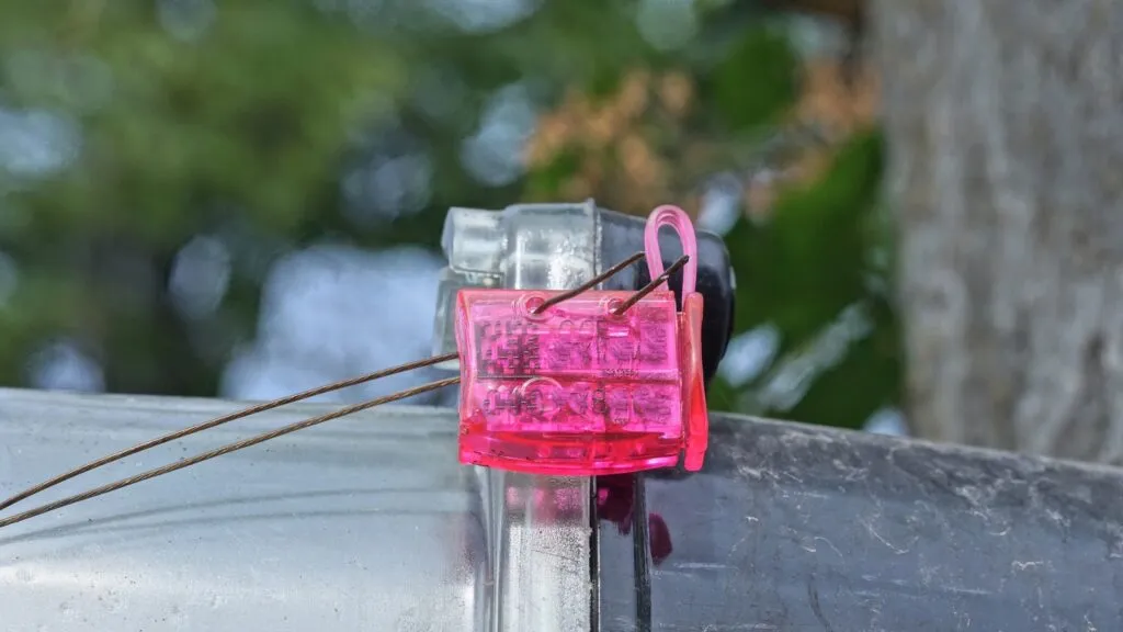 electric meter meter one purple plastic seal hanging on an electric meter outside