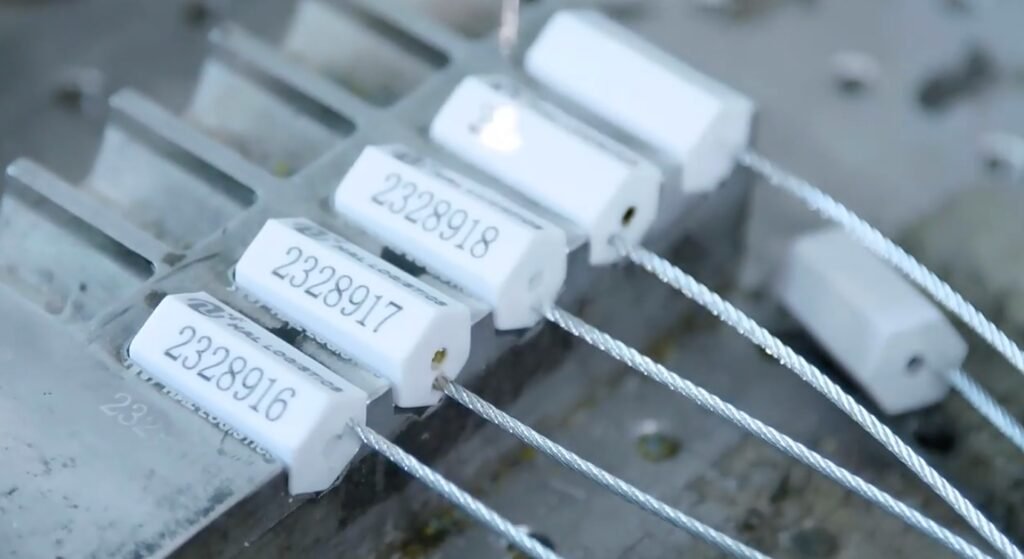 A close-up of a laser-engraved barcode and serial number on a security seal