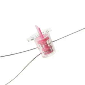 A close-up view of a high-security plastic meter seal with a thin wire attached.