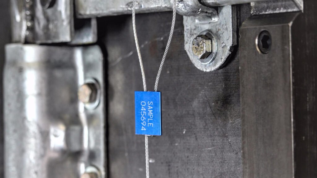 A steel cable seal looped through the valve of a tanker truck