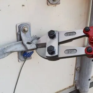 Proper tool and PPE for cable seal removal Heavy-duty bolt cutters are required for removing high-security cable and bolt seals