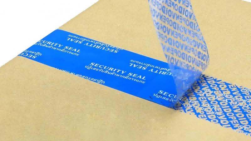 A blue security tape being peeled off a cardboard box, clearly showing the "VOID OPENED" message left behind