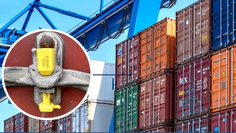  A shipping container being loaded onto a cargo ship, with a heavy-duty barrier seal clearly visible on the door handle.