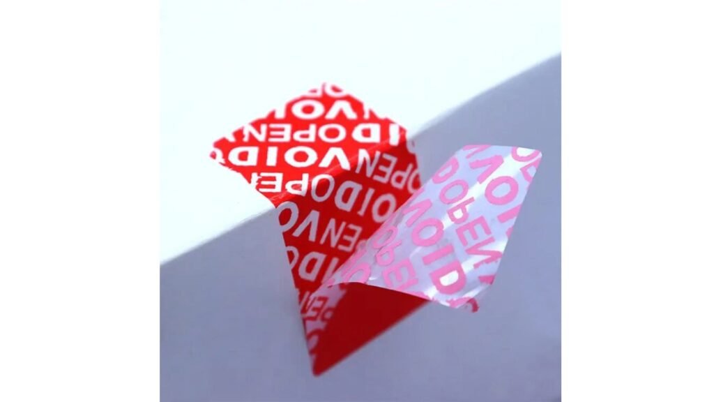 Full Residue VOID Label in Action A cardboard box with a peeled-off label, showing the clear and sticky "VOID OPENED" message left behind.