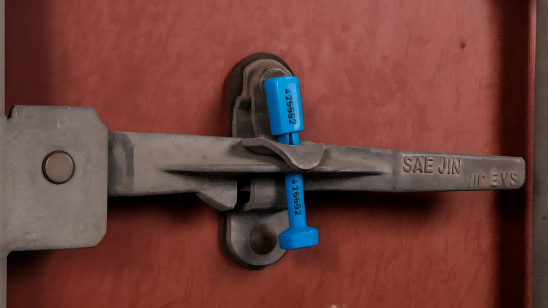 Showing a high-security bolt seal correctly placed on the right-hand door of a shipping container.