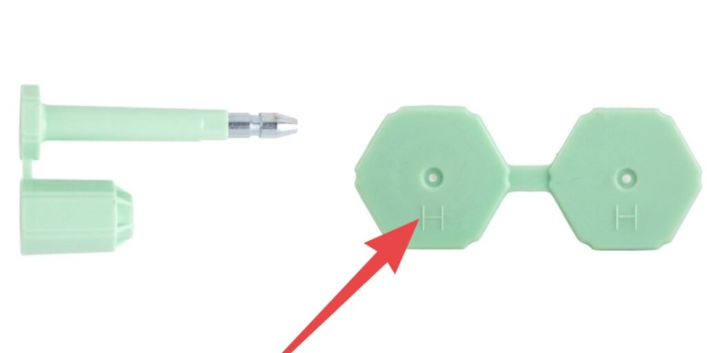 The 'H' Marking on a High-Security Bolt Seal A close-up photograph magnifying the "H" marking on the body of a bolt seal.