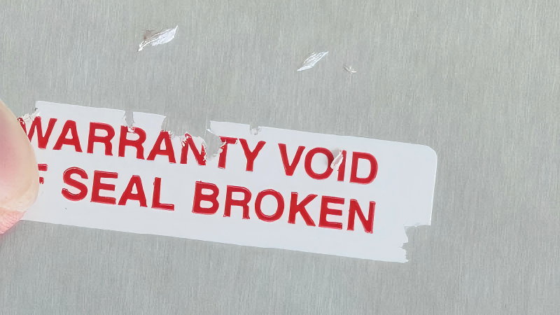 Visual Evidence of Tampering: Fragmented Residue A messy, chipped residue from a destructible label.