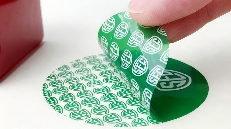 A security label that reveals a company logo instead of the word 'VOID' when peeled.