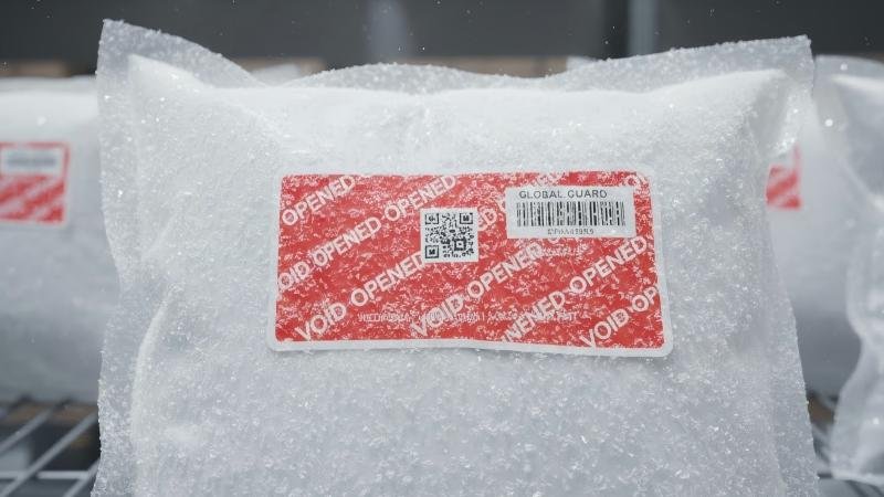 Frozen meat packaging with intact security label covered in frost