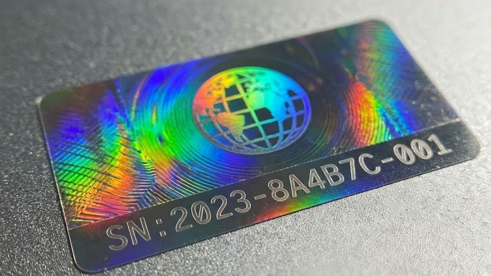 A hologram label that clearly shows a unique, laser-etched serial number along its edge.
